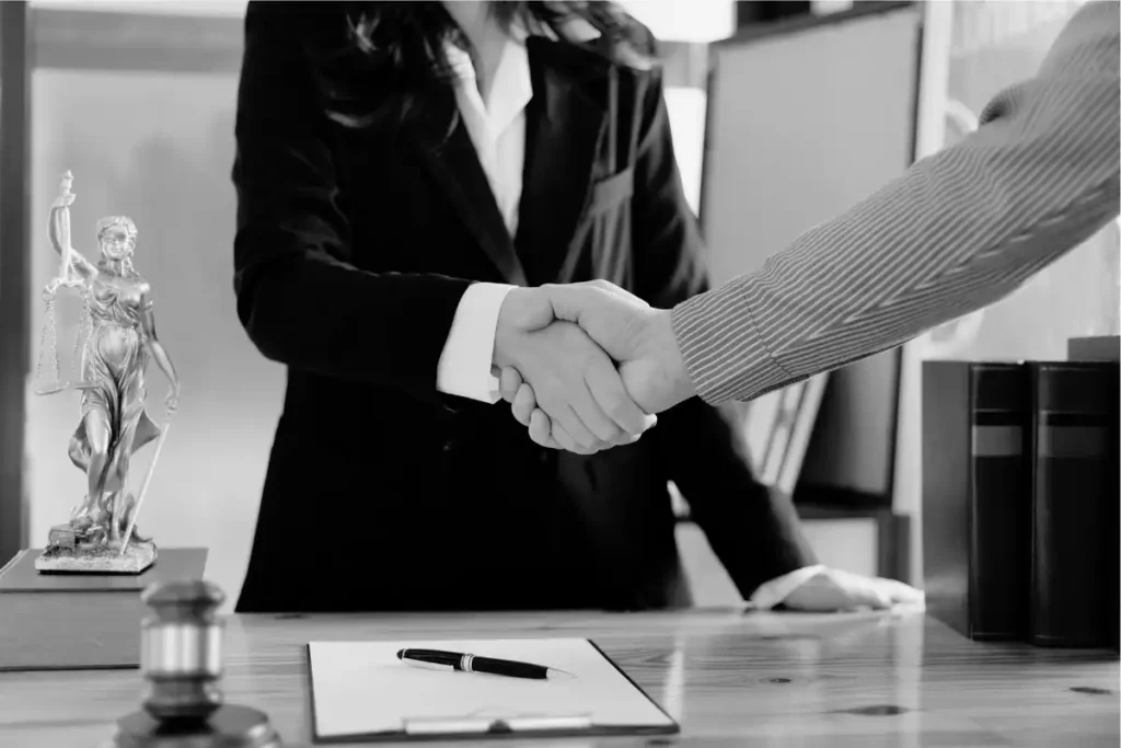 Two people shaking hands at Leger Law Wilmington